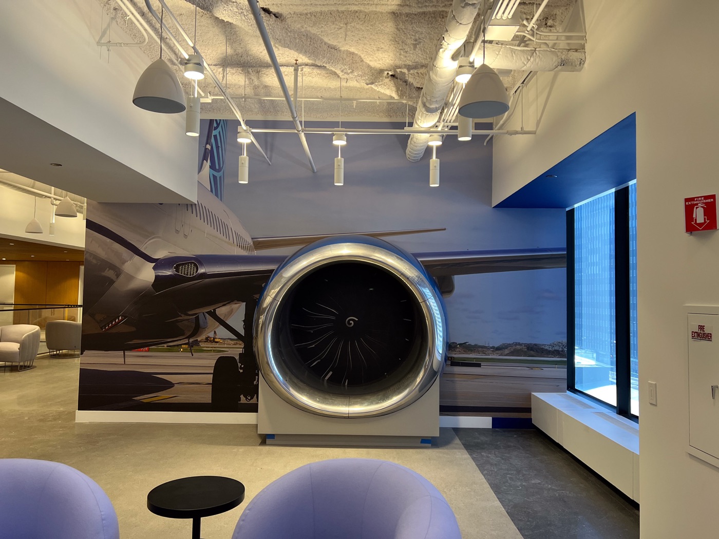 Branded lobby with a jet engine feature and blue accent wall