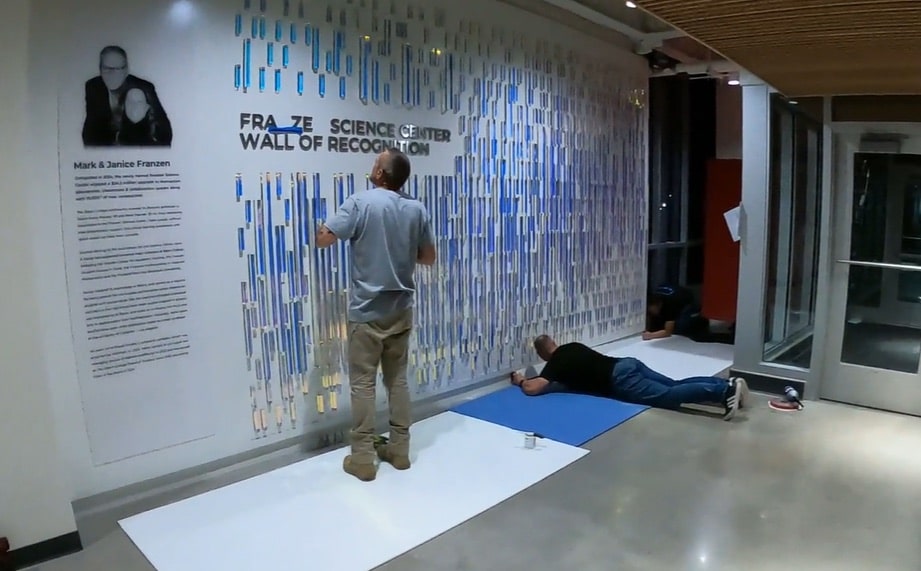 ER2 installers applying a wall of recognition graphic