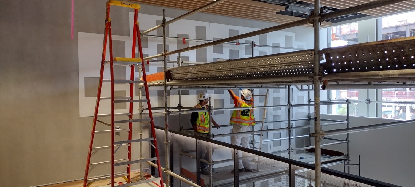 Scaffolding and ladders set up for a graphics installation