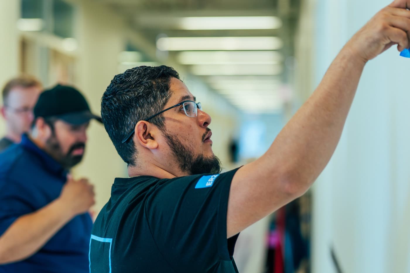 Installer applying a graphic on a corridor wall