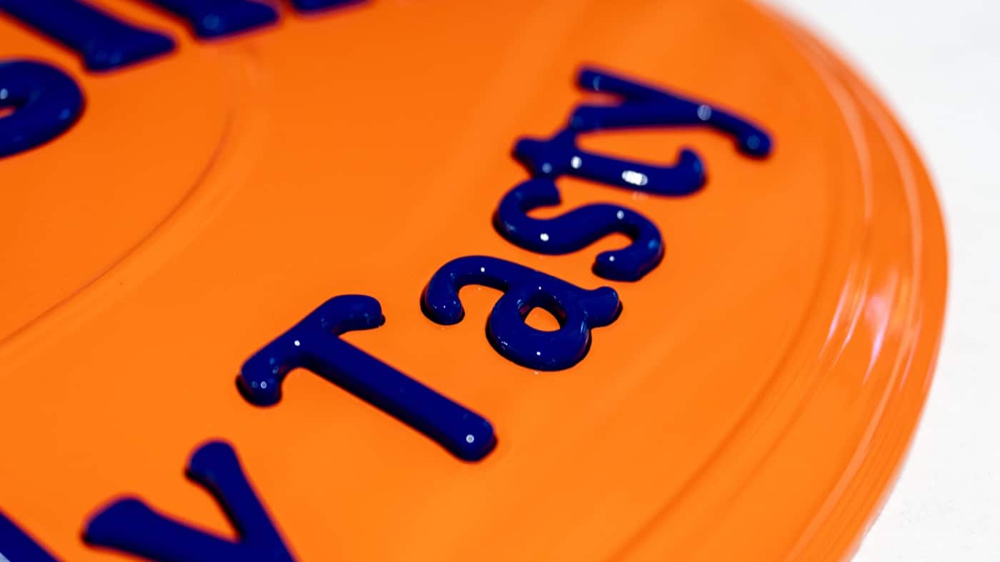 Close-up of dimensional lettering on an orange surface