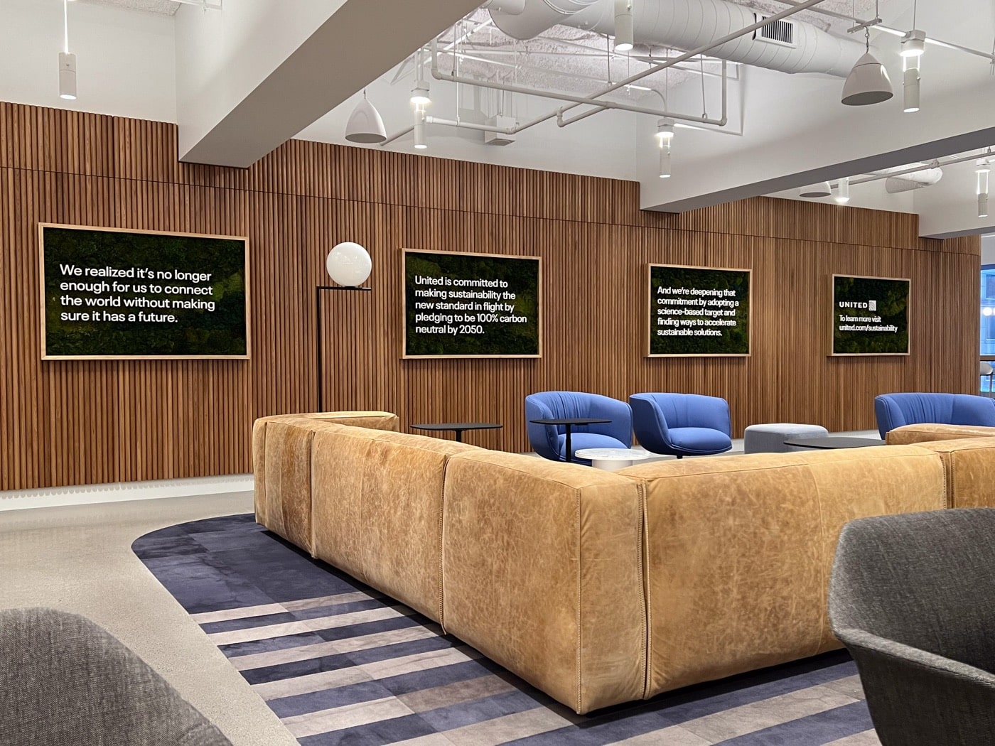 Lounge with wood paneling and integrated screens