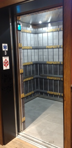 Elevator interior with branded wall graphics
